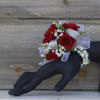 Classic red spray rose blooms with babies breath are showcased on a