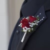 Classic red spray rose blooms with babies breath are showcased on a