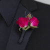 Bright pink blooms and greenery are showcased by black accents on a