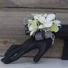 Classy white blooms and greenery are showcased on a black or silver