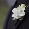 Classy white blooms and greenery are showcased on a black or silver