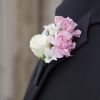 Light pink and white blooms and greenery are showcased on a silver