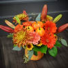 A warm gathering of gerbera daisies, mums, spray roses, carnations and a