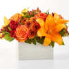 Step into autumn with fiery red and orange petals, expertly arranged to