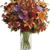 Brighten any fall day with this colorful array! Gorgeous orange lilies arranged