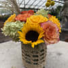 Bright yellow and orange flowers, including sunflowers, billy balls, roses, spray roses