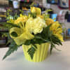 fresh yellow flowers in cupcake plastic vase 