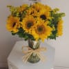 Beautiful vase arrangement with radiant sunflowers. 