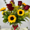 The red roses symbolize love and passion, while the bright yellow sunflowers
