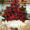 This striking arrangement features a luxurious cascade of deep red roses arranged