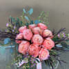 12 beautiful peach/coral/orange roses arranged low and lush.