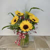Bright yellow sunflowers radiate sunshine and country charm with their bold, brown