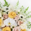 This stunning floral arrangement showcases a romantic mix of gold, blush and
