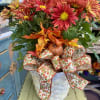 A beautiful, full mum plant in autumnal tones. Potted up in a