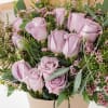 A gorgeous wrapped bouquet designed with premium 1 Dozen Lavender Roses, Wax