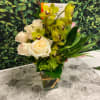 This chic arrangement has graceful movement and artistic style. Filled with greens
