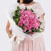 A lush gathering of 25 premium roses, artfully arranged in the classic