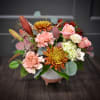 Beautiful lilies, fluffy mums and a wooden flower designed in a pottery
