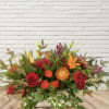 A boxed autumnal low and long arrangement.