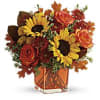 Sunny sunflowers and radiant roses in a happy orange cube vase bring