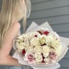 A refined bouquet blending ivory roses, delicate lilies, and bold touches of