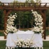 A breathtaking wedding set featuring a graceful floral arch and a refined