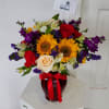Crystal red vase with sunflowers, alstroemeria, stock, roses, and statice. 

(Picture depicts