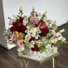 A festive Rosh Hashanah arrangement featuring vibrant pomegranates, golden honey jars, and