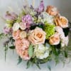 A delicate and elegant arrangement in soothing pastel hues, featuring classic roses