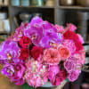 A stunning, lush arrangement artfully designed in a beautiful ceramic vase, featuring
