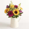 Make someone&rsquo;s day a lot brighter with this mixed arrangement in a