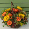  Assorted  blossoms in a homey wicker basket. Selection varies by