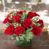 One dozen red Roses in a square vase with seasonal accents and