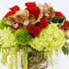 in a glass vase roses, hydrangeas, orchids, arranged and will be delivered