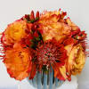 in a very nice vase dosen of orange roses and 6 cushions