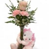 Bunny Hugs and Blooms is a charming and heartwarming arrangement that combines