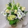 This exquisite arrangement features a delicate combination of white roses, green ball