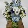 Immerse yourself in a tranquil oasis with our enchanting Sky-Blue flower arrangement