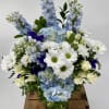 Immerse yourself in a tranquil oasis with our enchanting Sky-Blue flower arrangement