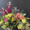 A lovely floral arrangement with a crystal cross suitable for sending to