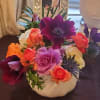 Rich gem tones set in a white ceramic pumpkin. Ranunculus, anemone and