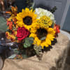 bronze pumpkin filled with fall flowers hydrangea, roses, yarrow