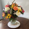 vase with hydrangeas, roses, kale, and other seasonal flowers