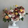A charming arrangement of warm-toned roses that evoke the richness of a
