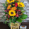 Autumn Glow is a warm and inviting floral arrangement featuring bright sunflowers