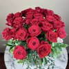 12 beautiful extra long stem roses with fine greenery arranged in a
