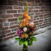 The Blissful Autumn is artfully arranged with roses, spider mums, stock, gladiolas