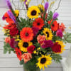 Beautiful assortment of bright,  colorful fall blooms arranged artfully for you.