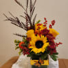 Fly into fall with this cheery arrangement of sunflowers, roses, chrysanthemums, berries