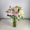 Queen Anne&#039;s lace is sprinkled around roses and lilies. This beautiful arrangement